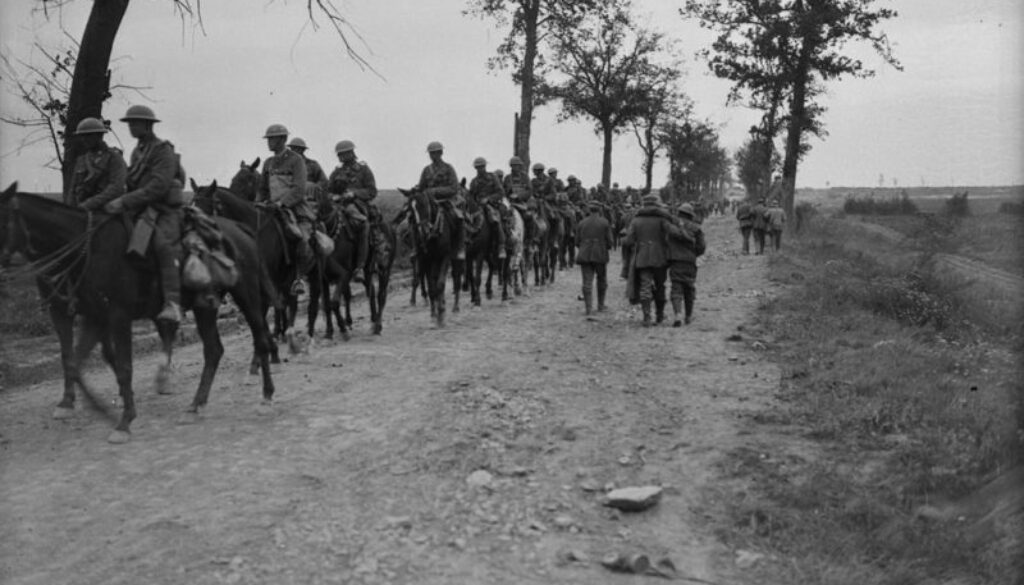 113_Canadian Cavalry going forward passing German wounded. Advance East of Arras. September, 1918.